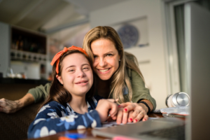 a mother smiling next to her child with special needs