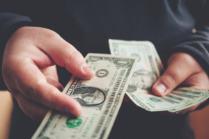 hands holding cash