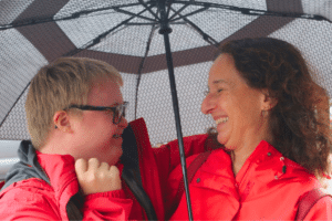 woman and child with special needs under an umbrella